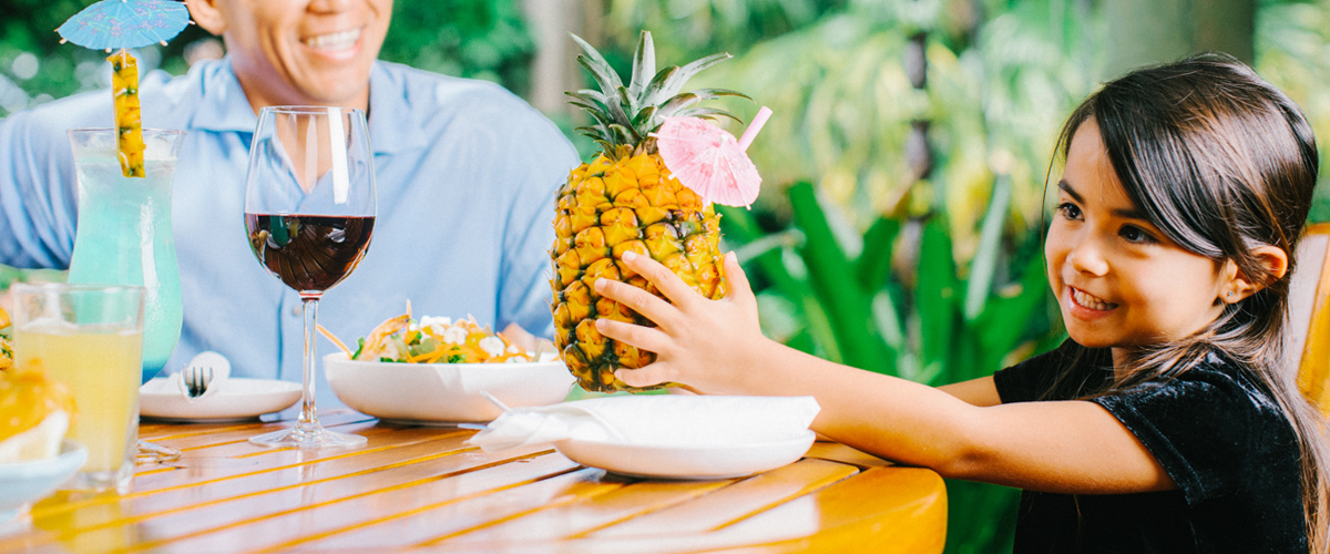 Little girl smiling with her pineapple