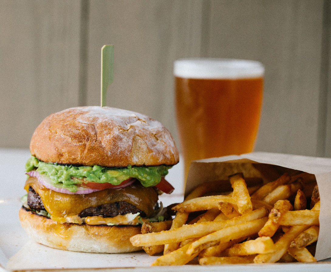 photo of a burger, fries, and a beer